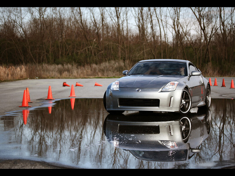 Silver sports car on wet track