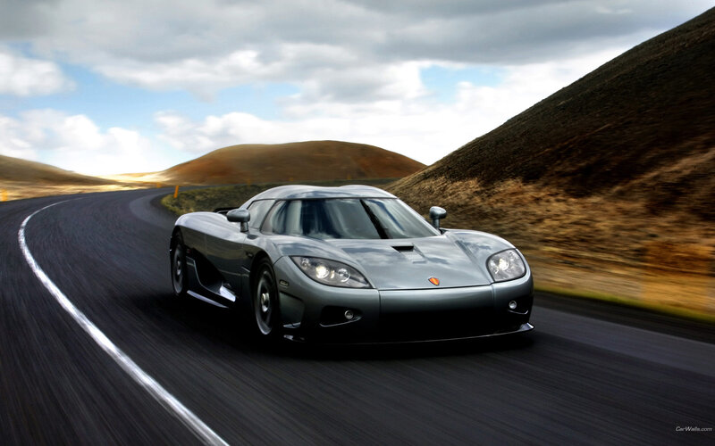 silver sports car on winding road