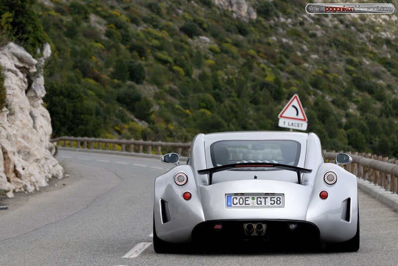 silver sports car on winding road