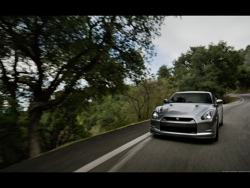 silver sports car on winding road