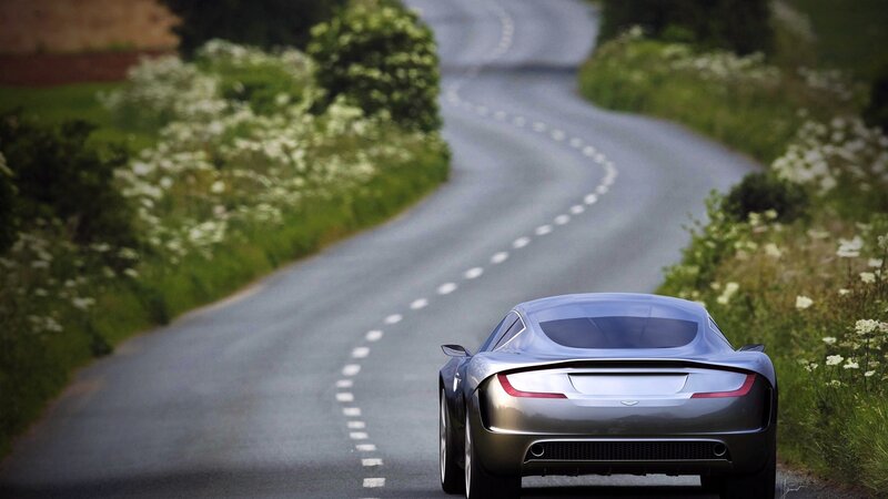 silver sports car on winding road