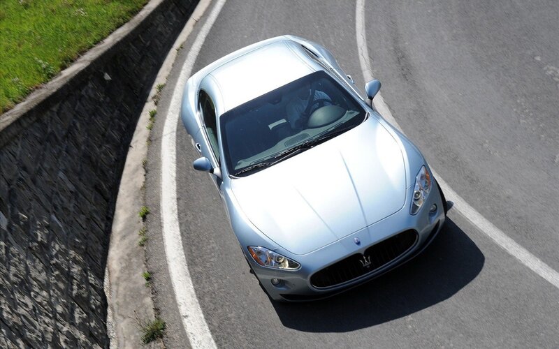 silver sports car on winding road