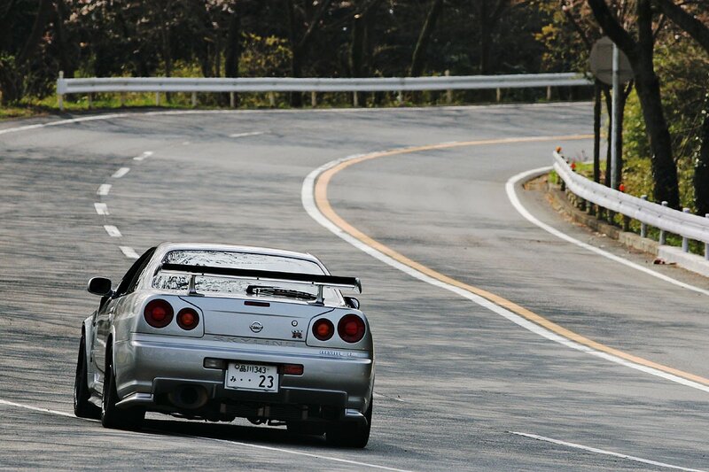 silver sports car on winding road
