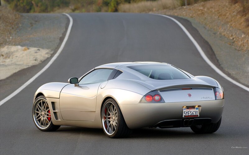 silver sports car on winding road