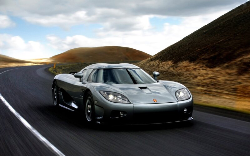 silver sports car on winding road