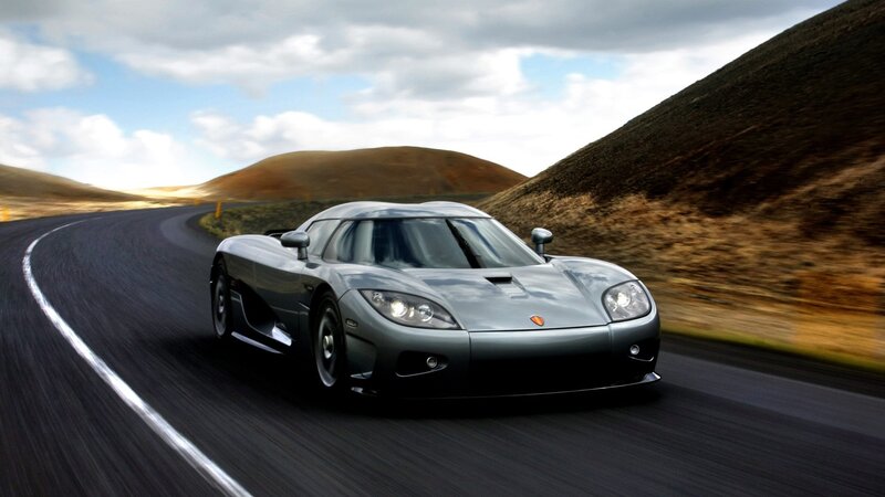 silver sports car on winding road