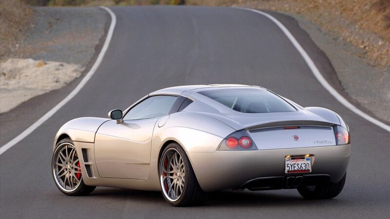 silver sports car on winding road