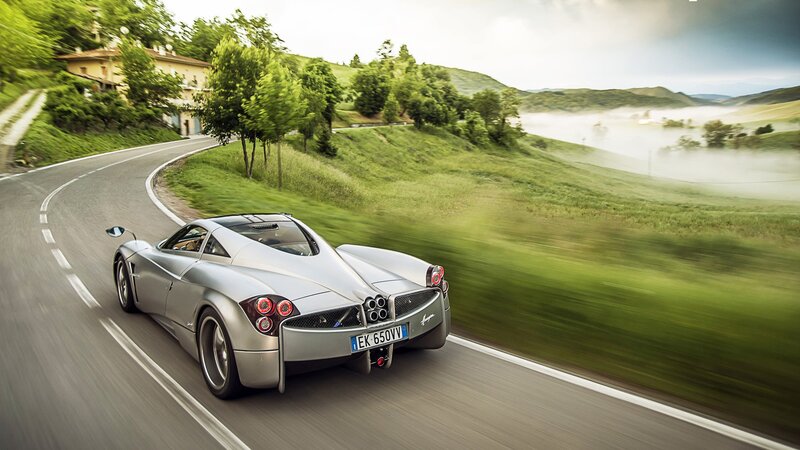 silver sports car on winding road