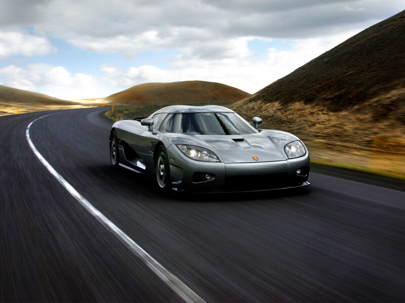 silver sports car on winding road