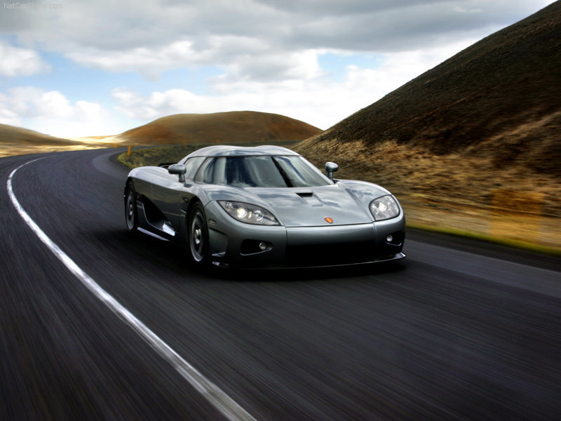 silver sports car on winding road
