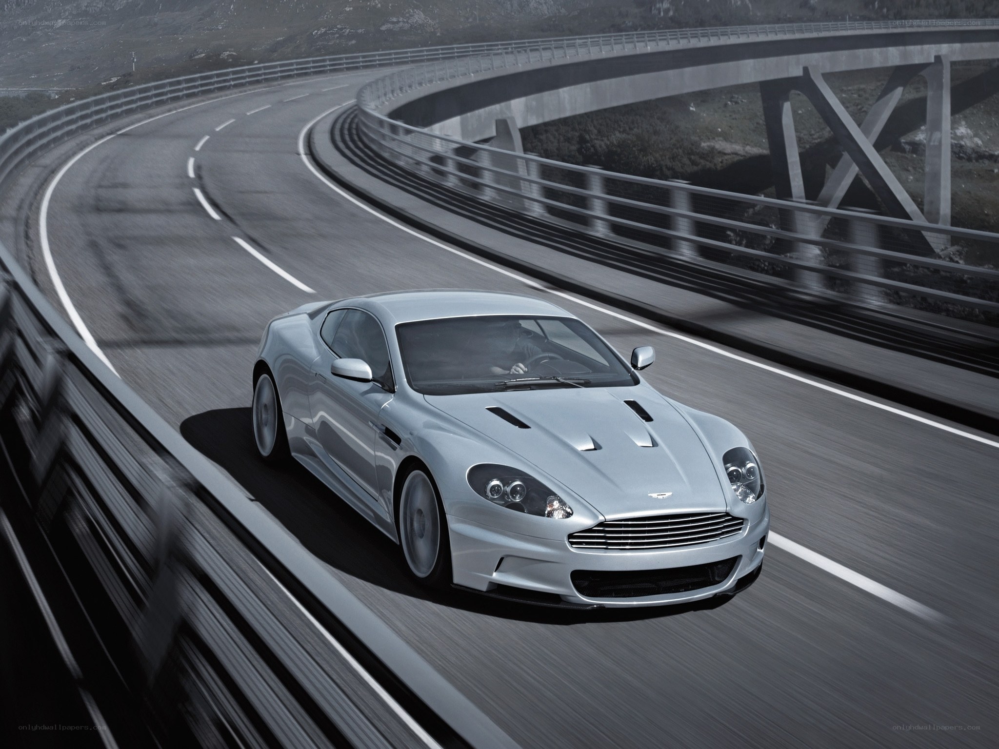 silver sports car on winding road