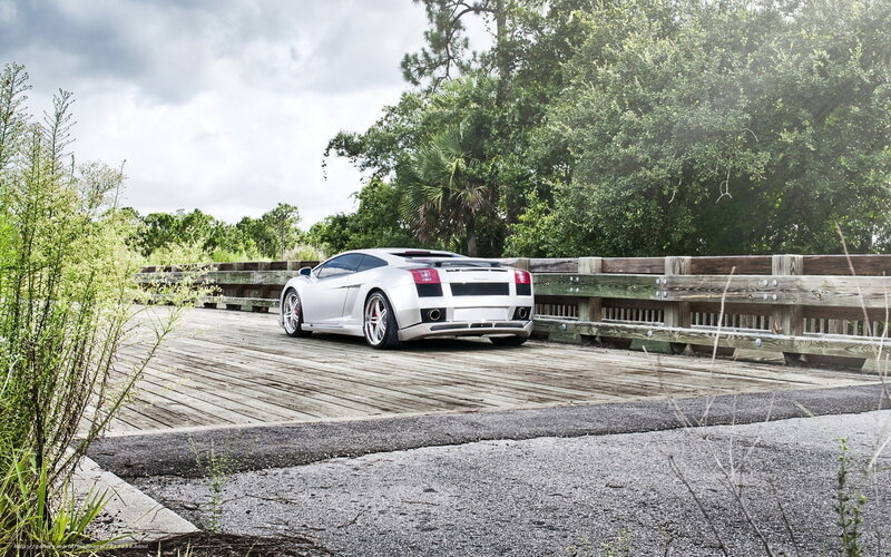 silver sports car on wooden bridge