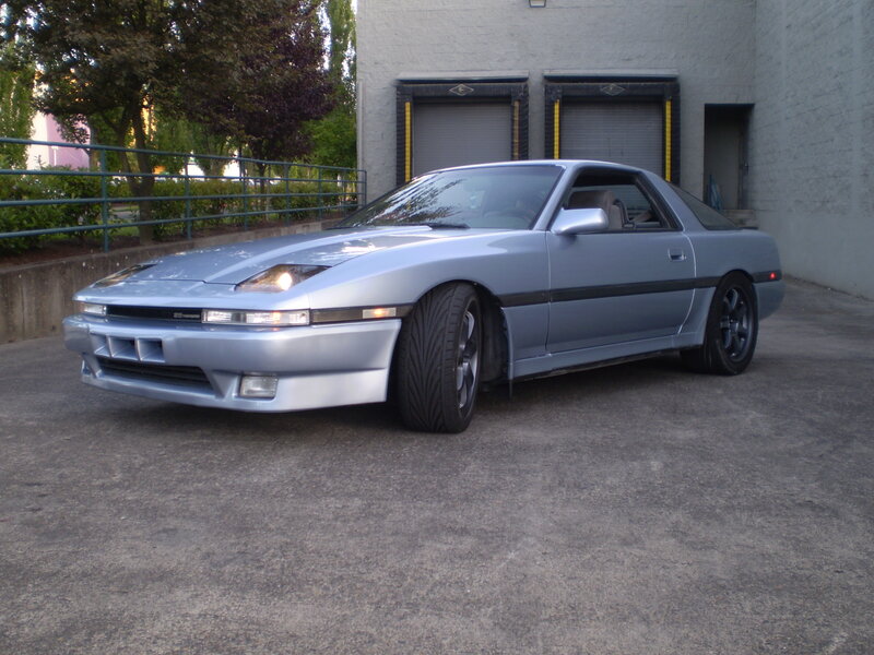 silver sports car parked outside