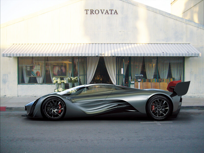 Silver sports car parked outside a building