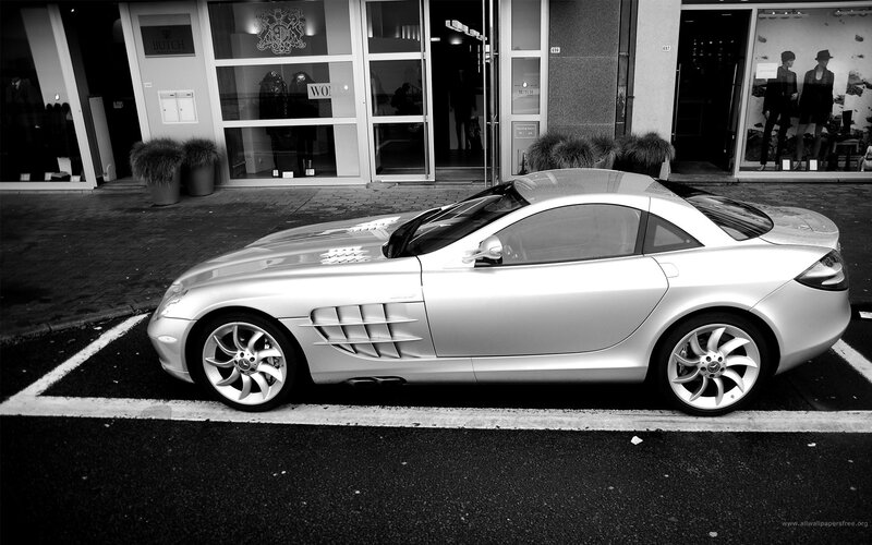 Silver sports car parked outside store