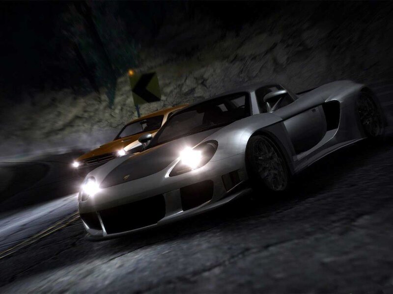 Silver sports car racing at night