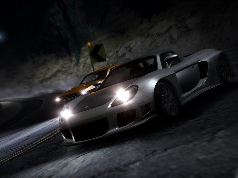 Silver sports car racing at night