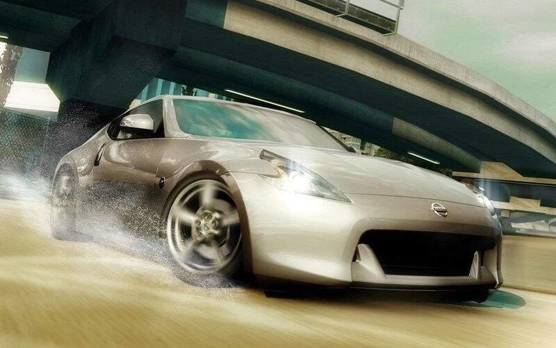 Silver sports car speeding under bridge