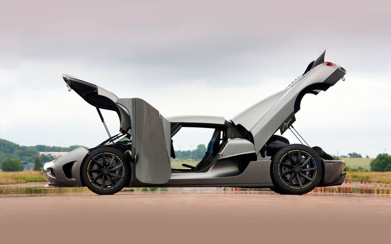 silver sports car with doors open