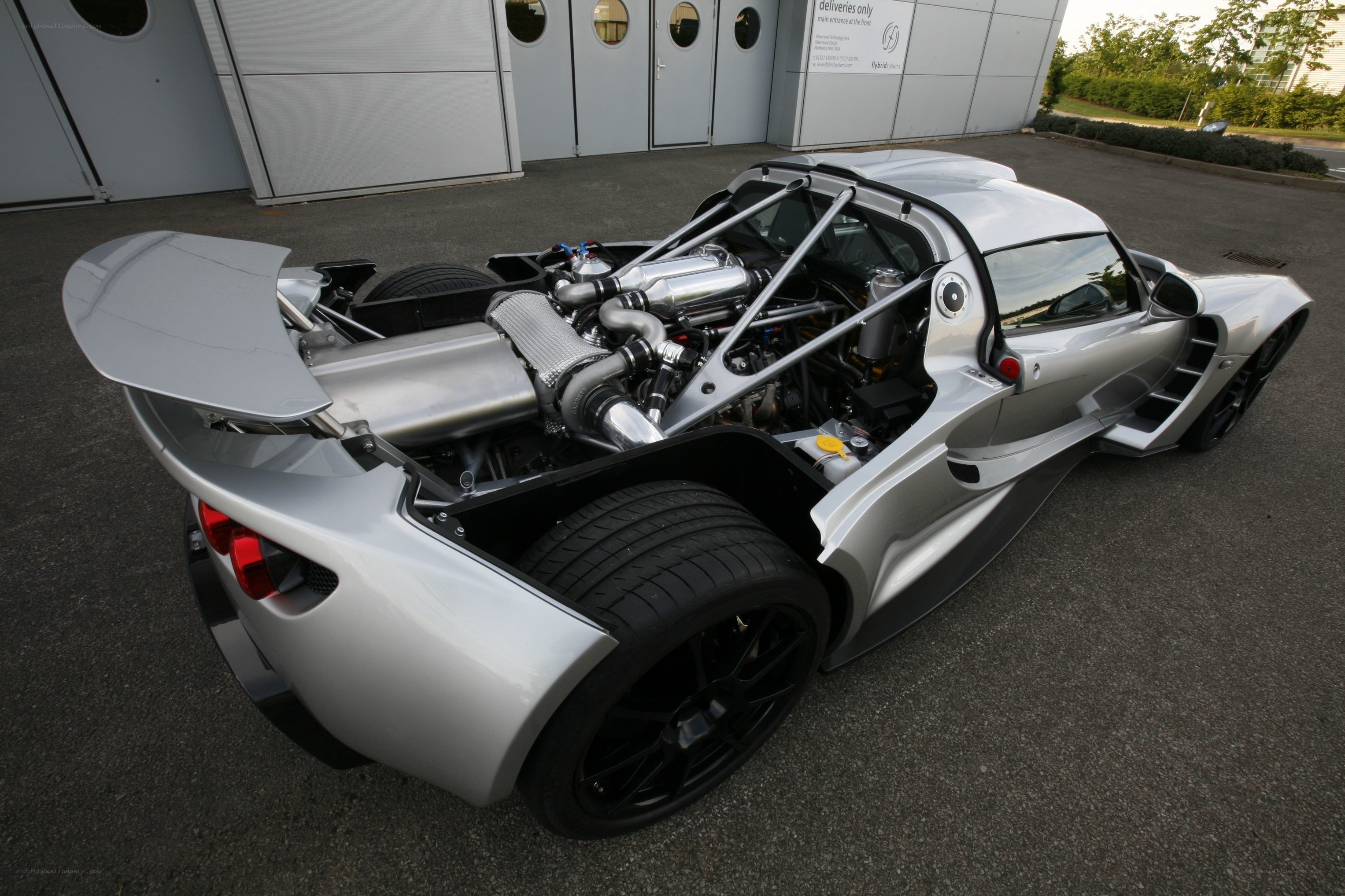 silver sports car with exposed engine