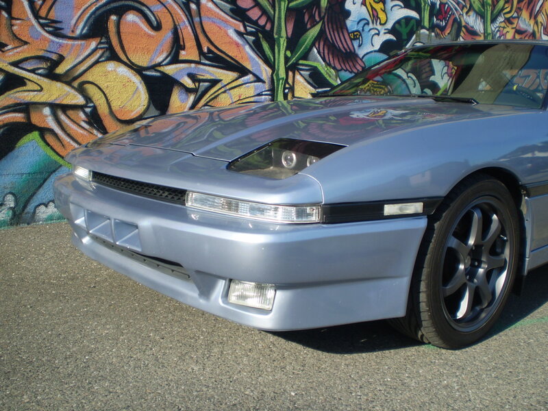 silver sports car with graffiti