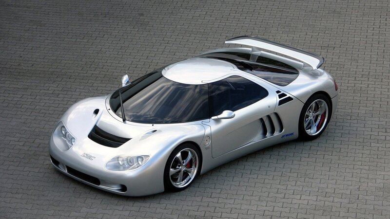 silver sports car with large wing