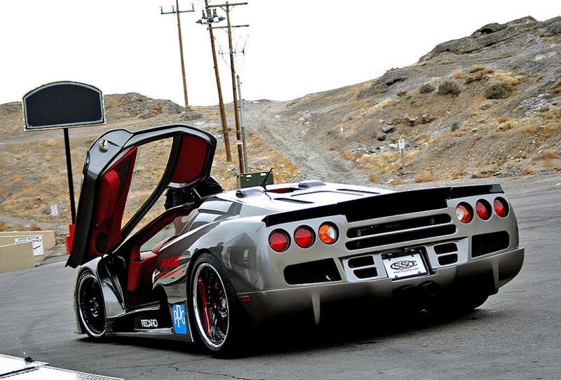 silver sports car with open door
