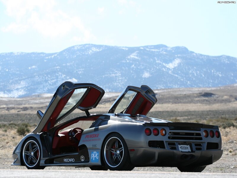silver sports car with open doors