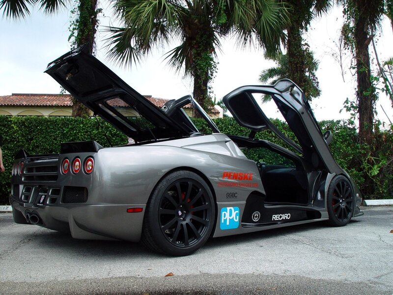 silver sports car with open doors