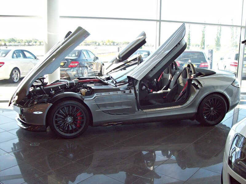 Silver sports car with open doors