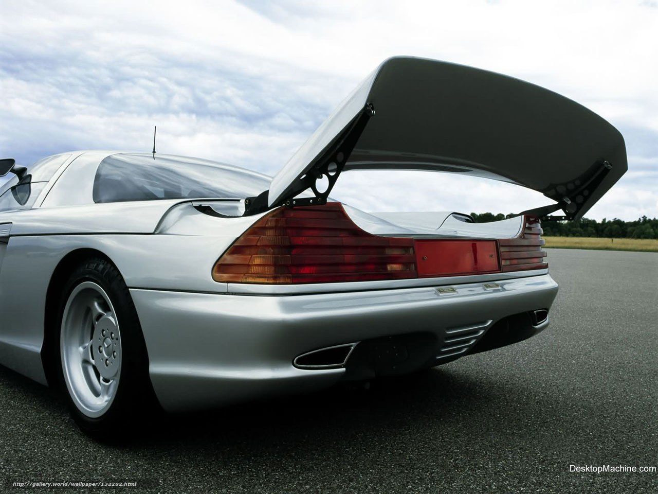 silver sports car with open trunk