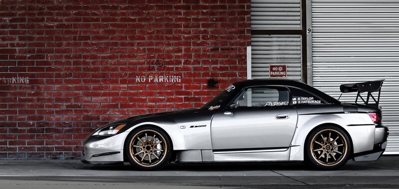 silver sports car with rear wing