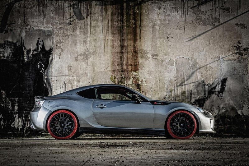 Silver sports car with red wheels