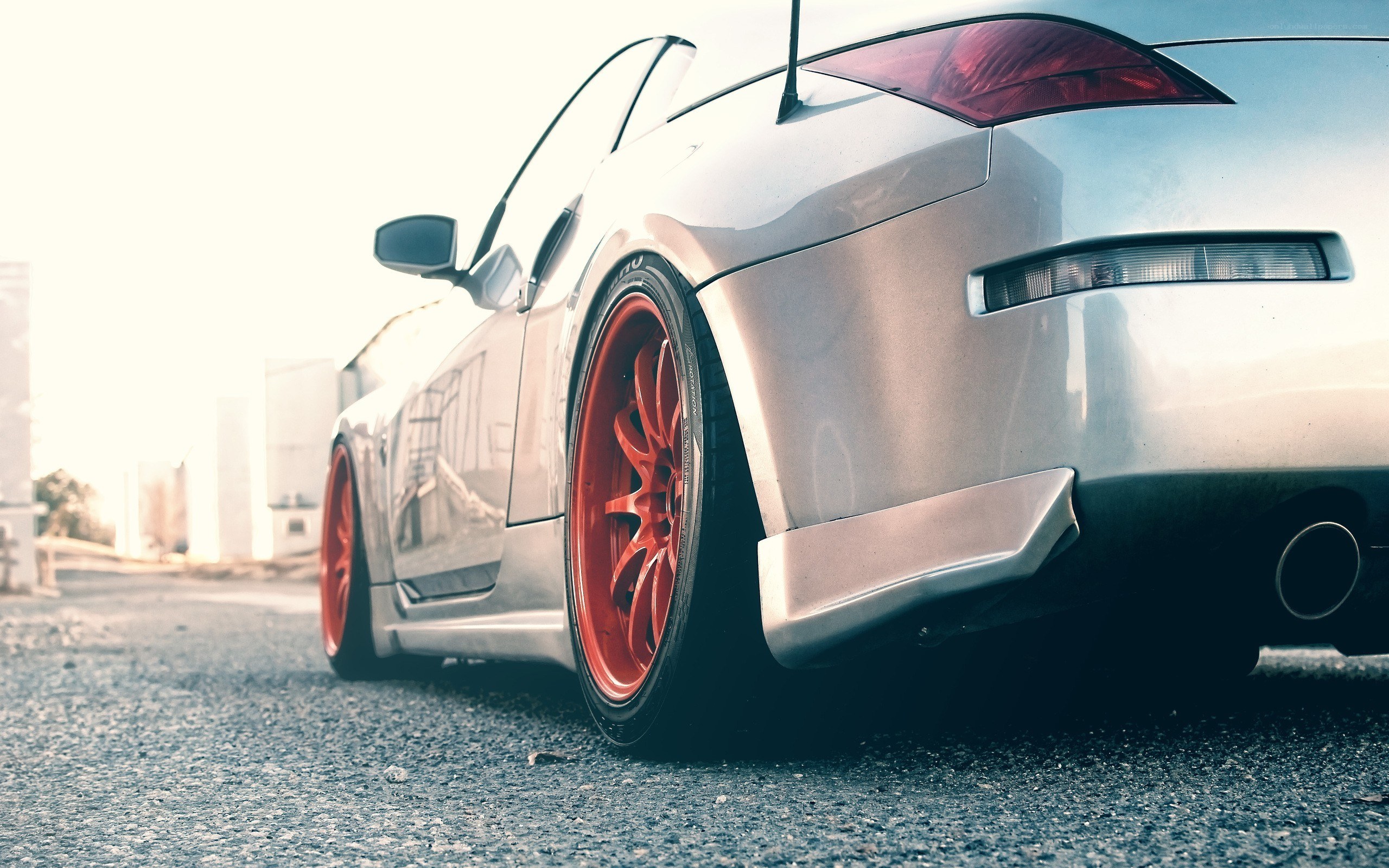 silver sports car with red wheels