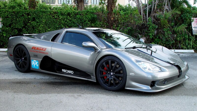 silver sports car with sponsor decals