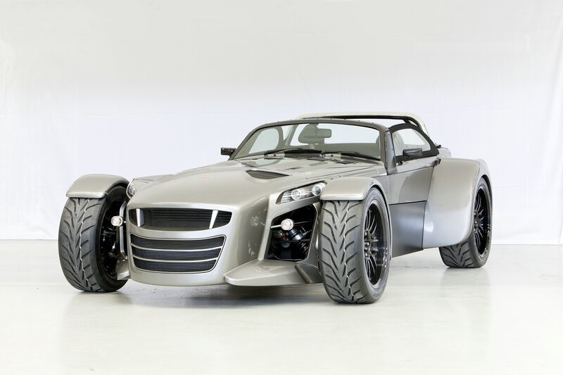 silver sports car with wide tires