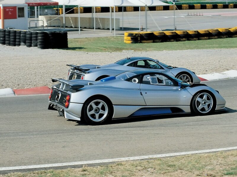 Silver sports cars on a racetrack