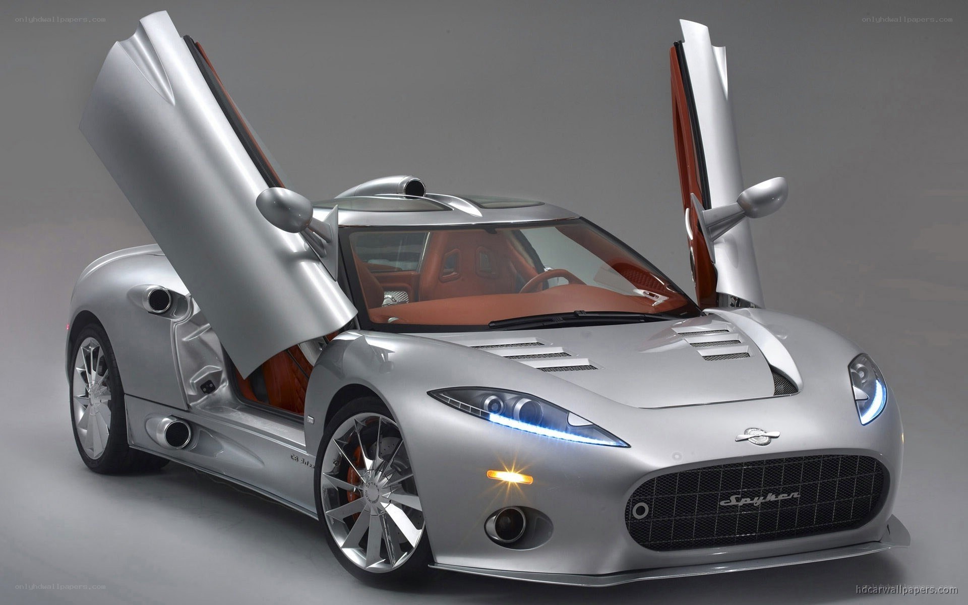 silver spyker car with doors open