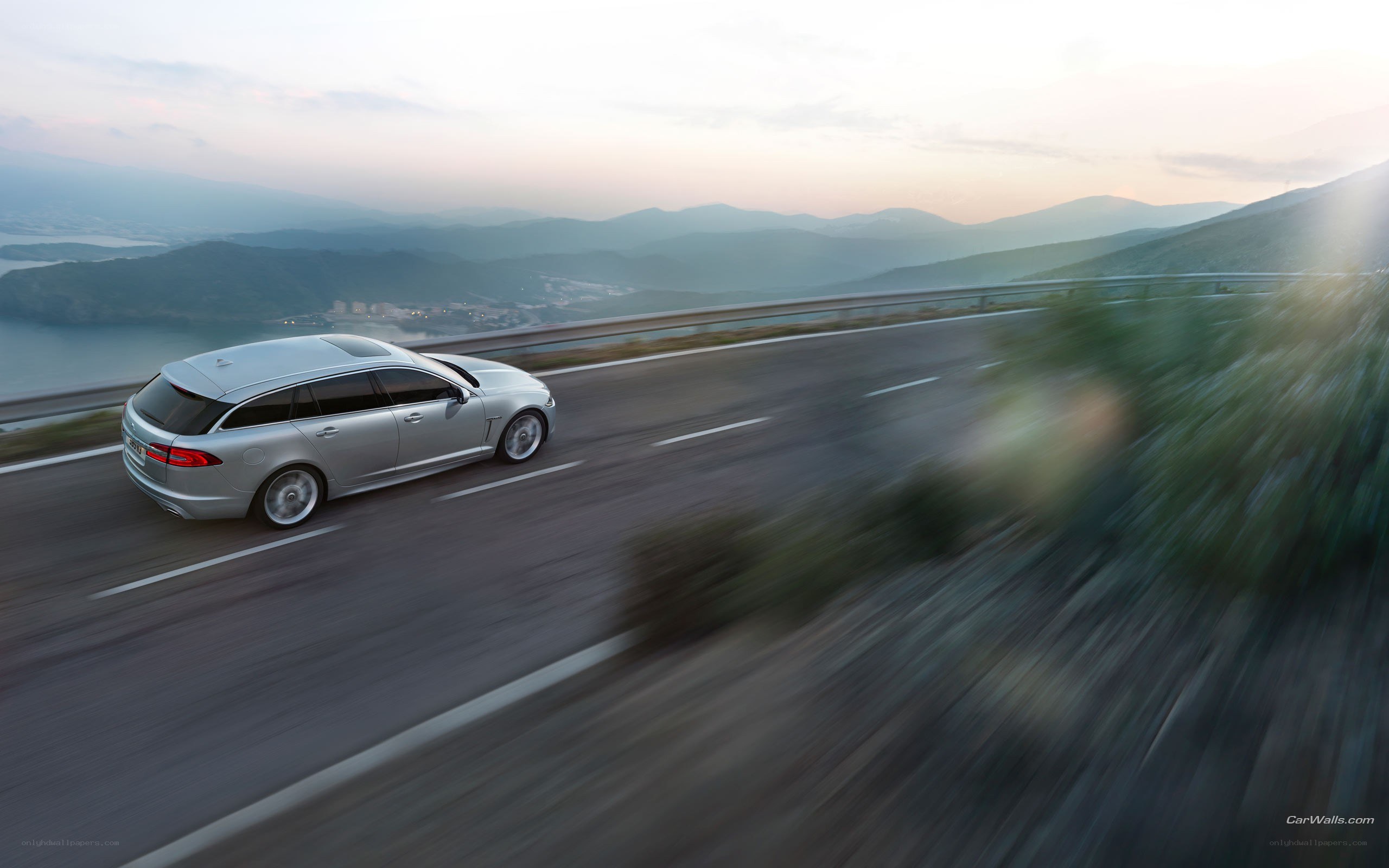 silver station wagon on mountain road