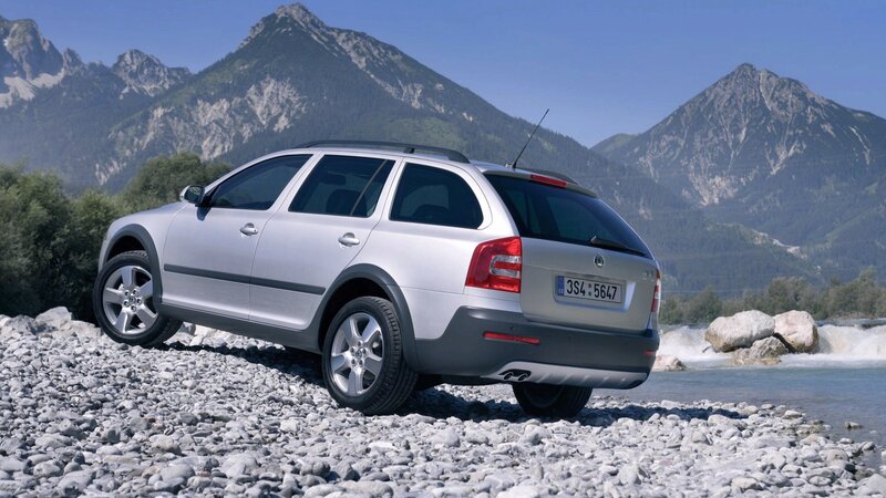 Silver station wagon on riverbank