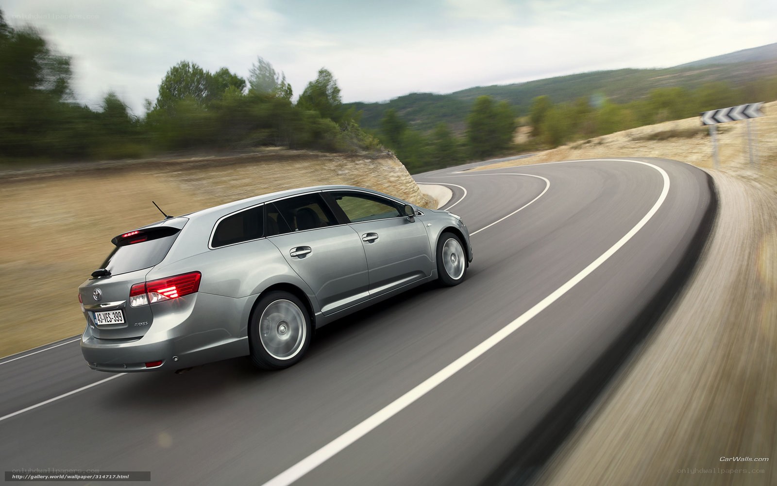 silver station wagon on winding road
