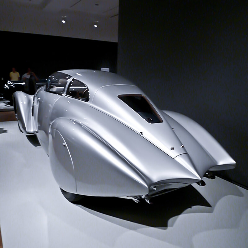 Silver streamlined car on display