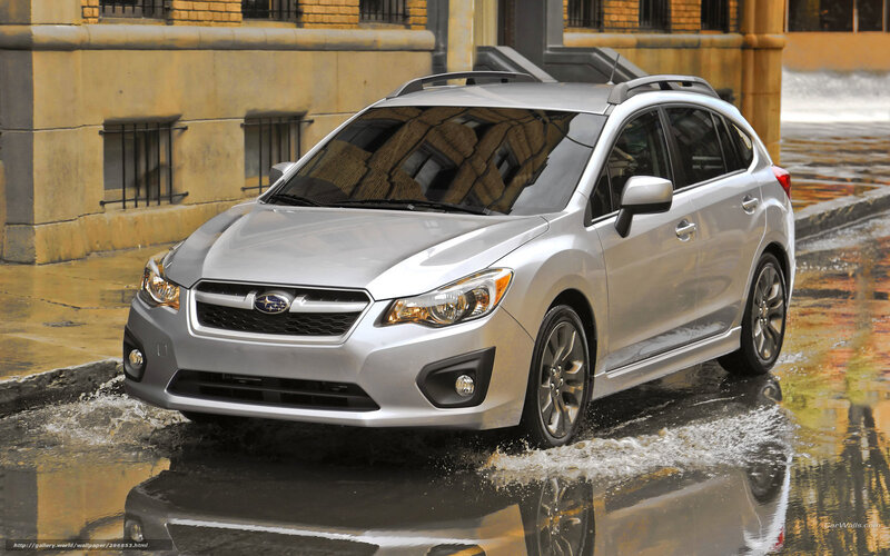 Silver Subaru driving in rain