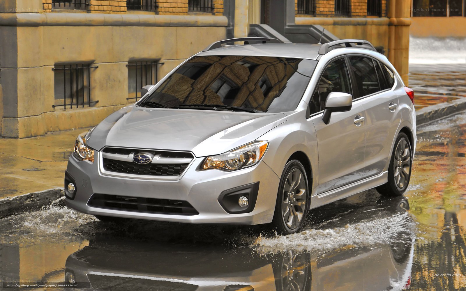 Silver Subaru driving in rain