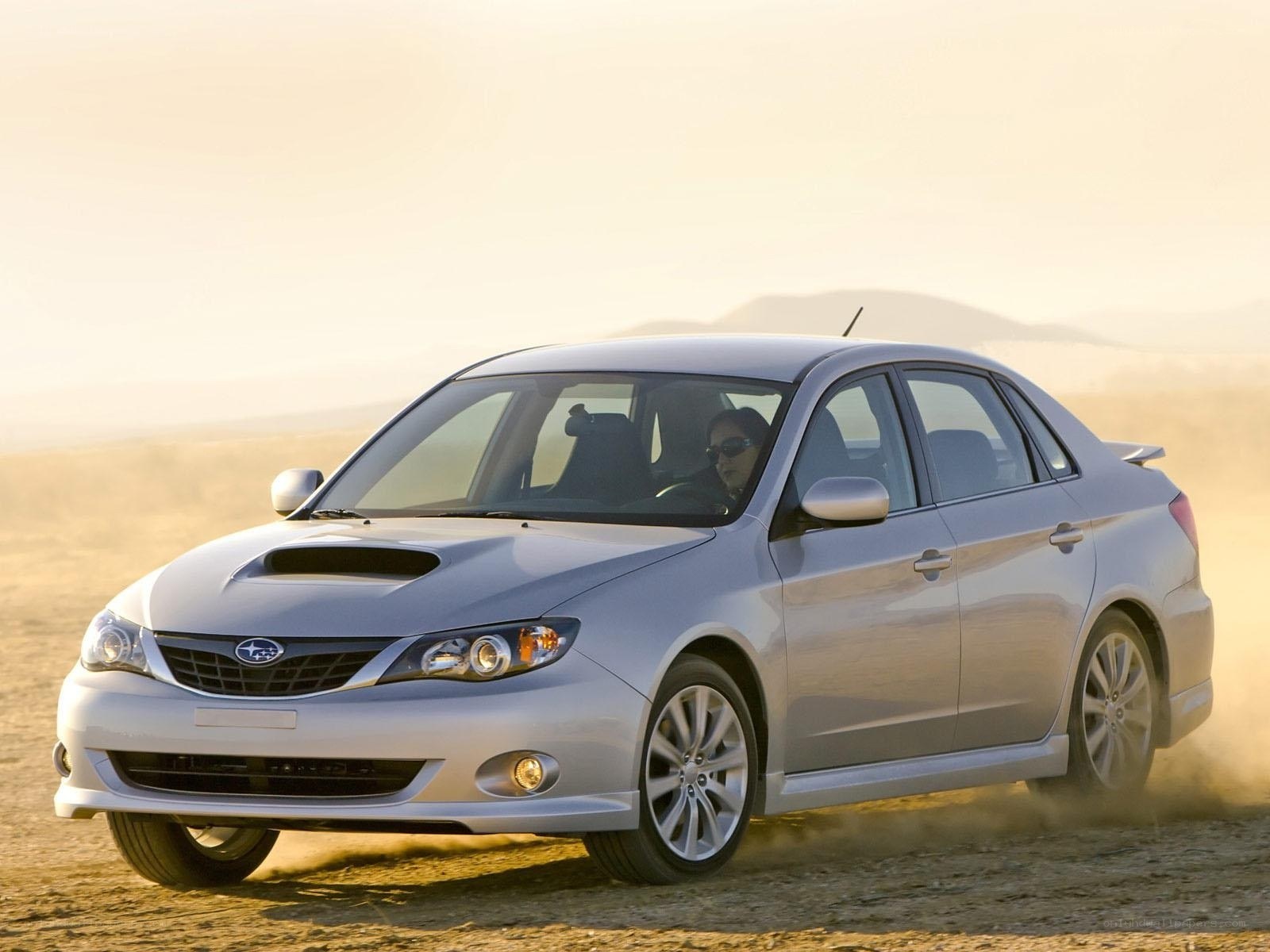 silver subaru driving on dirt