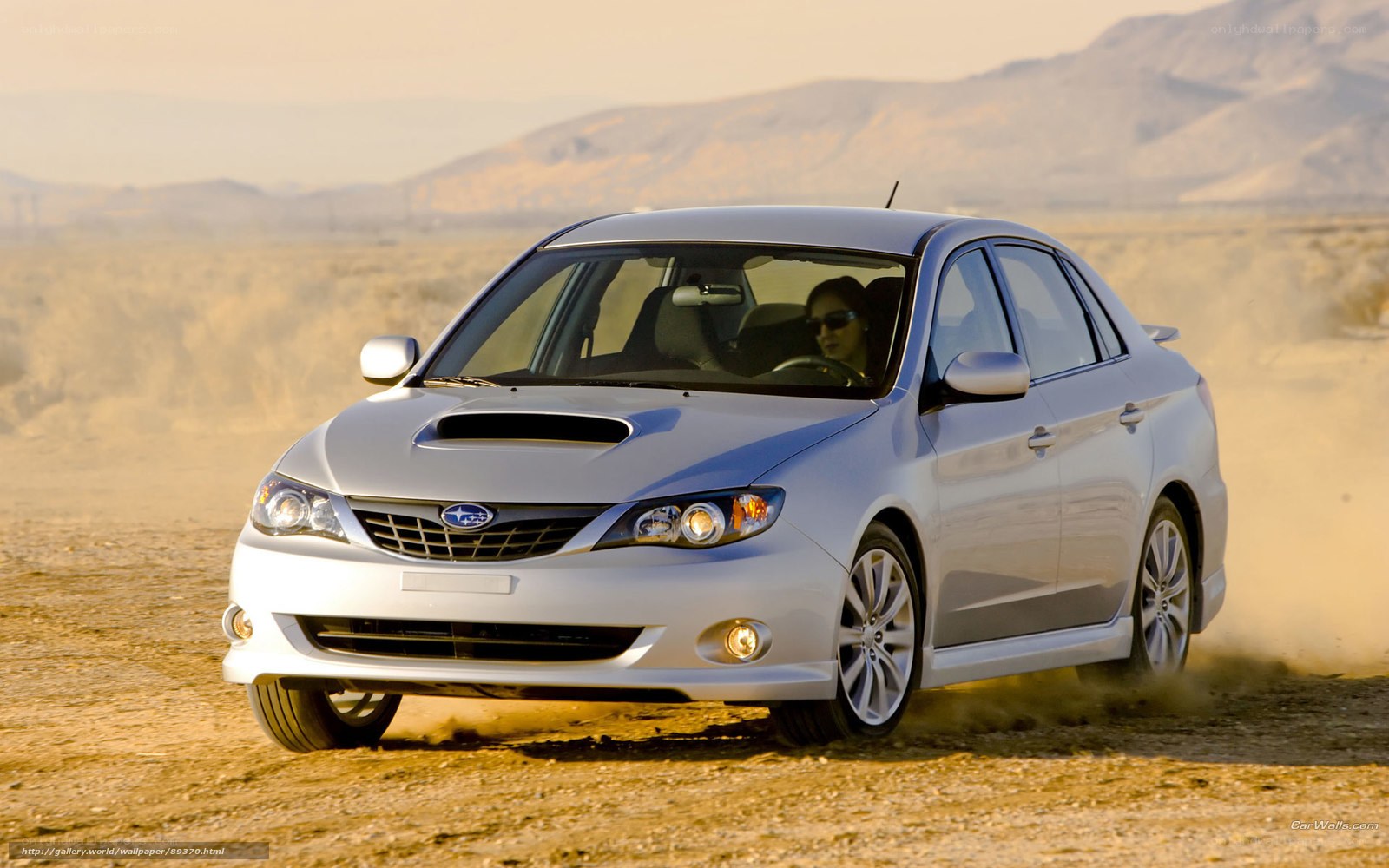 silver subaru driving on dirt