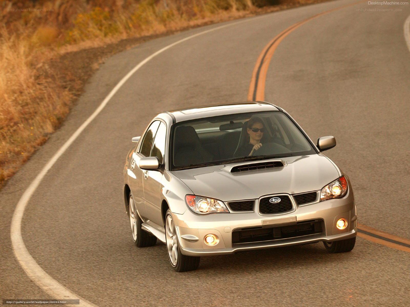 silver subaru driving on road
