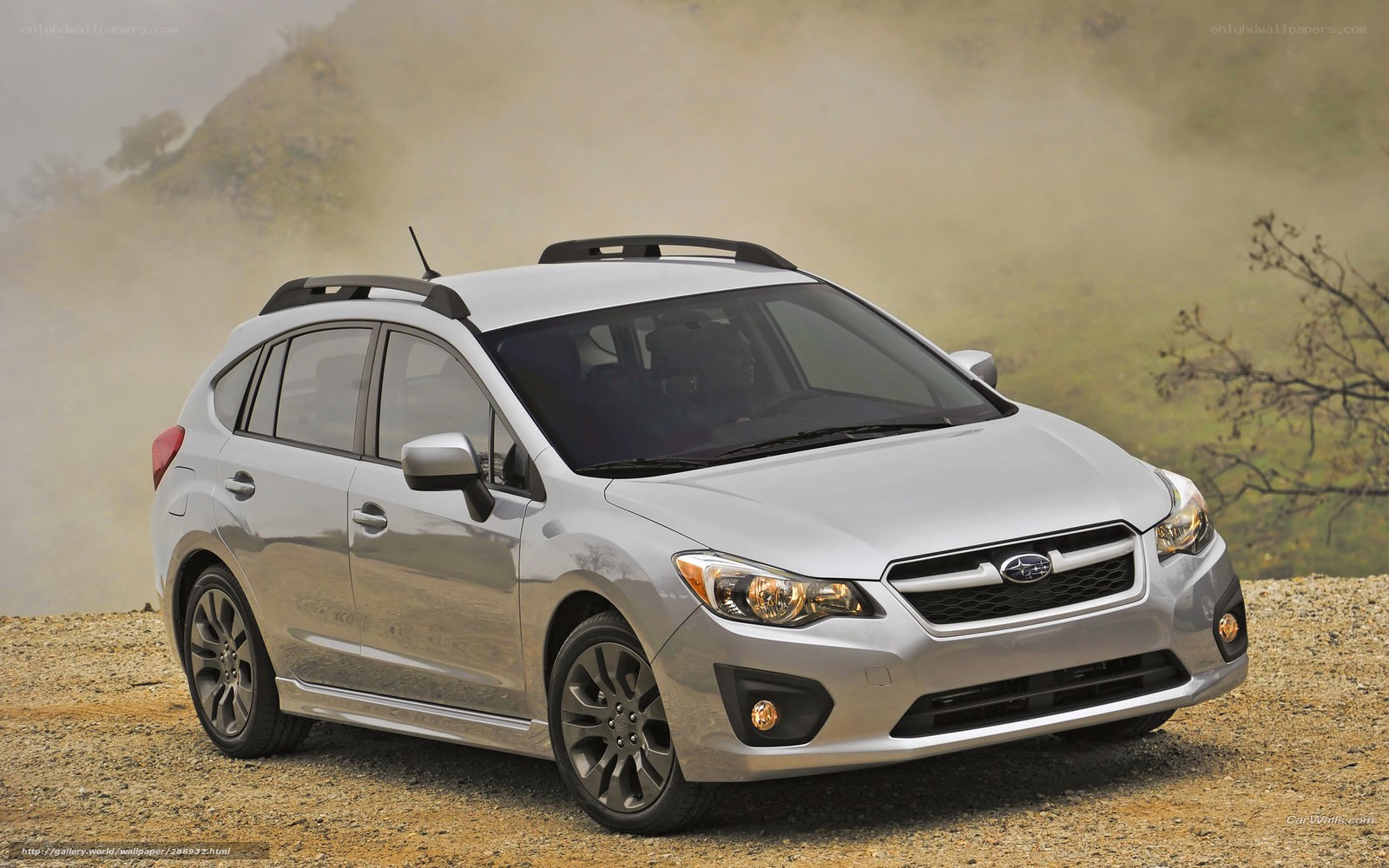 silver subaru hatchback on dirt road