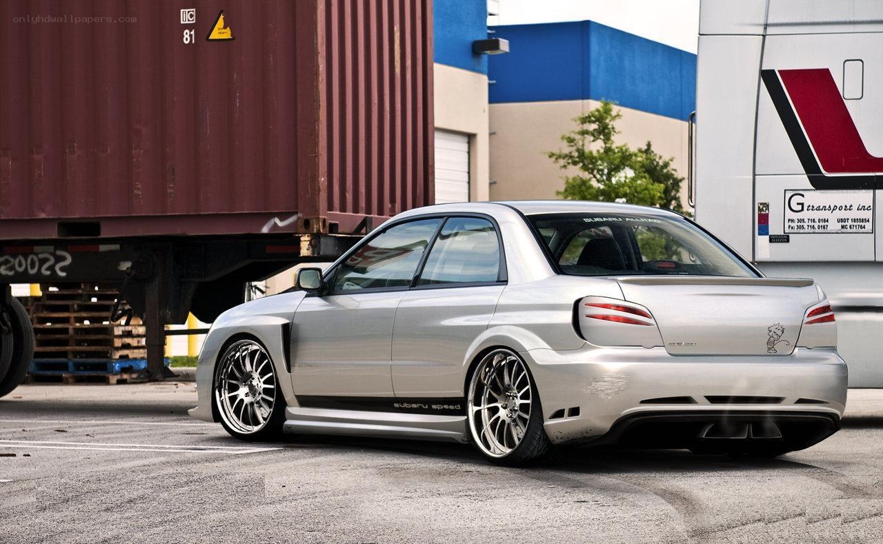 silver subaru in industrial lot