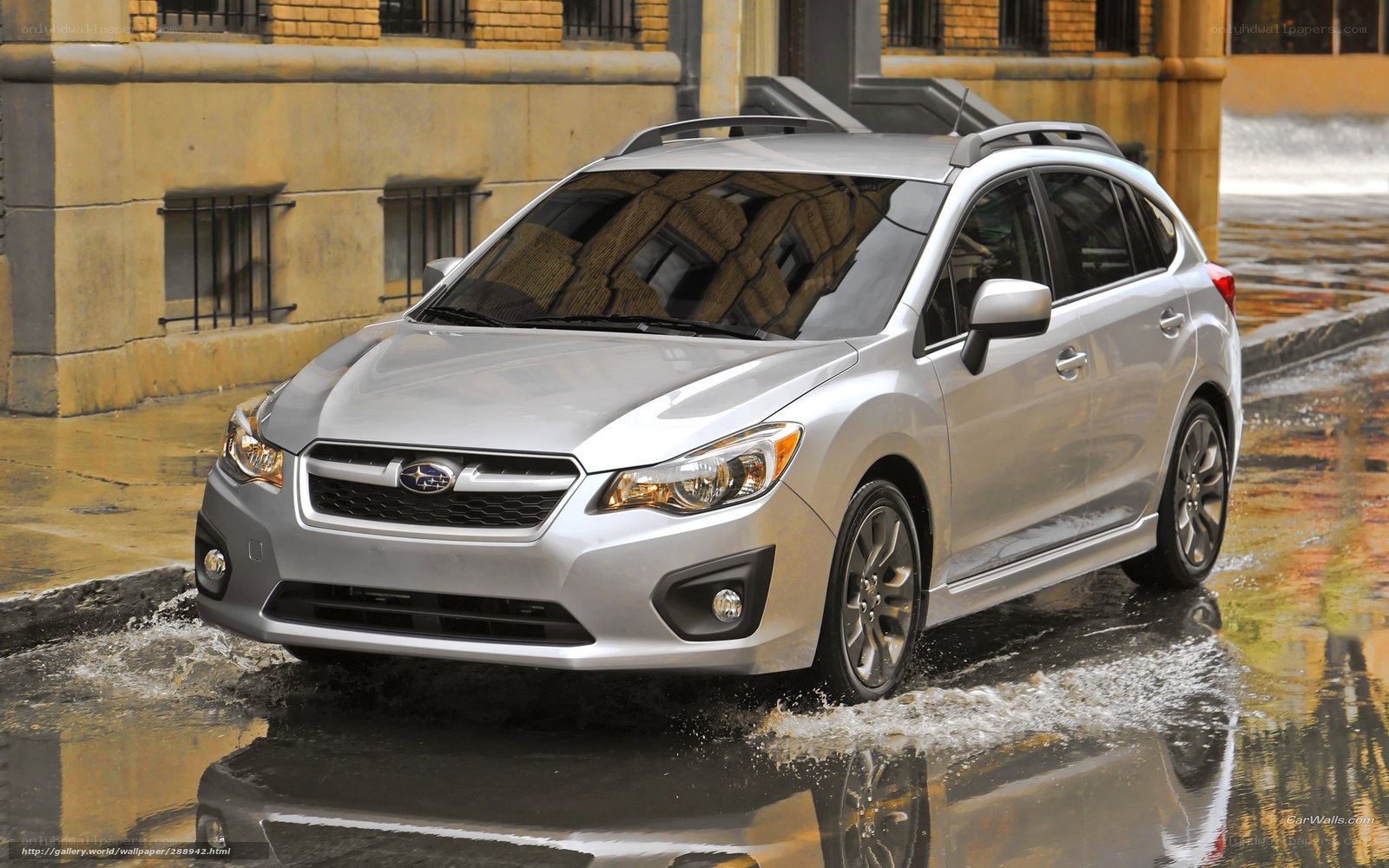 silver subaru in wet city